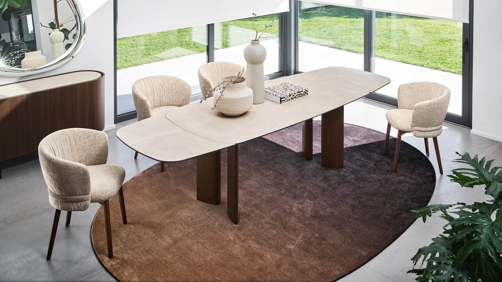 Calligaris dining table and upholstered chairs in a bright contemporary dining room.