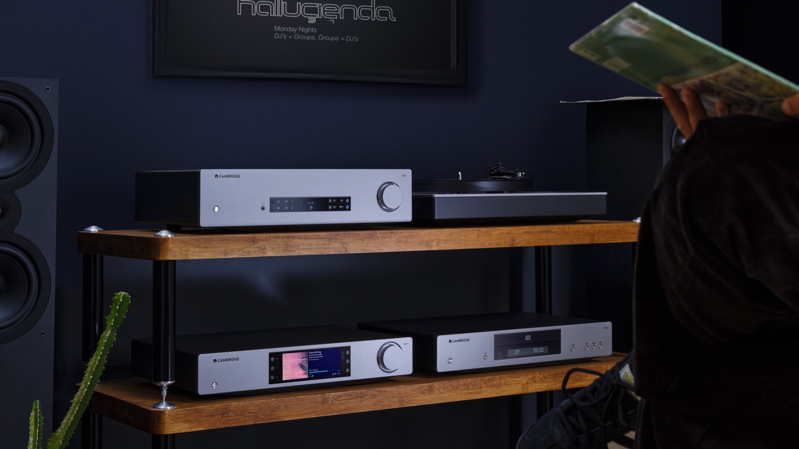 Cambridge Audio CXA81 amplifier, CXN100 streamer, CXC CD transport and turntable arranged on wooden hi-fi shelves.