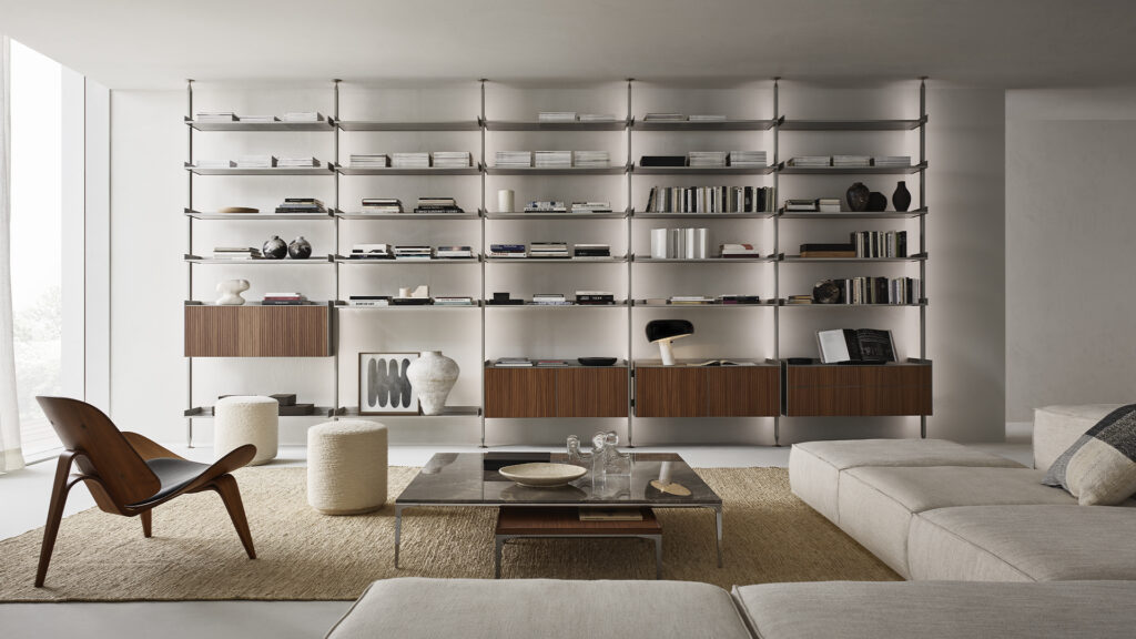 Rimadesio Zenit bookcase with suspended wood-front cabinets in a furnished living room.